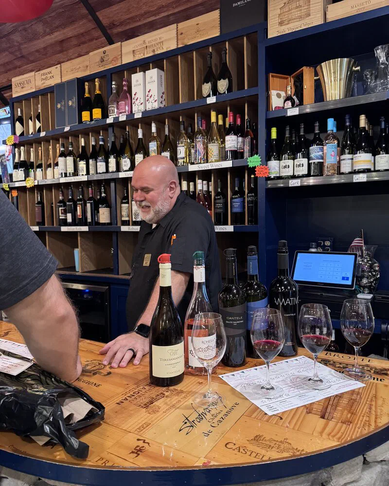 Matt pouring and explaining a flight to guests at the wine bar at Carfagna&rsquo;s
