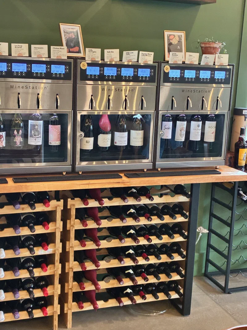WineStation dispensers and wine racks at a tasting room — the physical infrastructure a fractional digital lead supports
